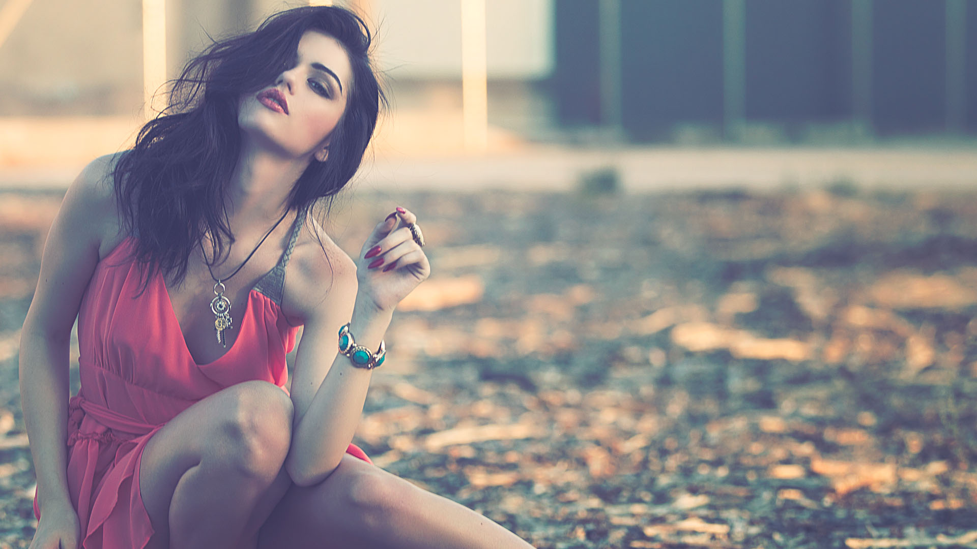 Editorial fashion portrait of a model in a coral dress with turquoise jewelry, shot by GoBig Films