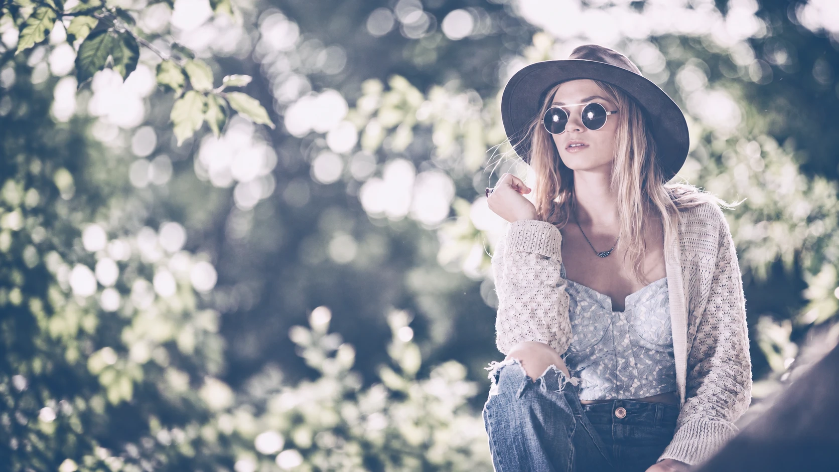 Lifestyle portrait of a model in a hat and round sunglasses, shot by GoBig Films