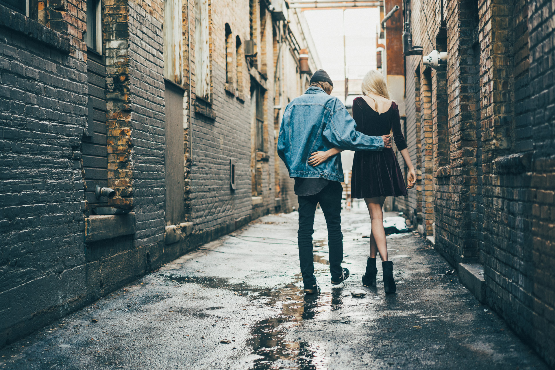 Urban couple walking in brick alley
